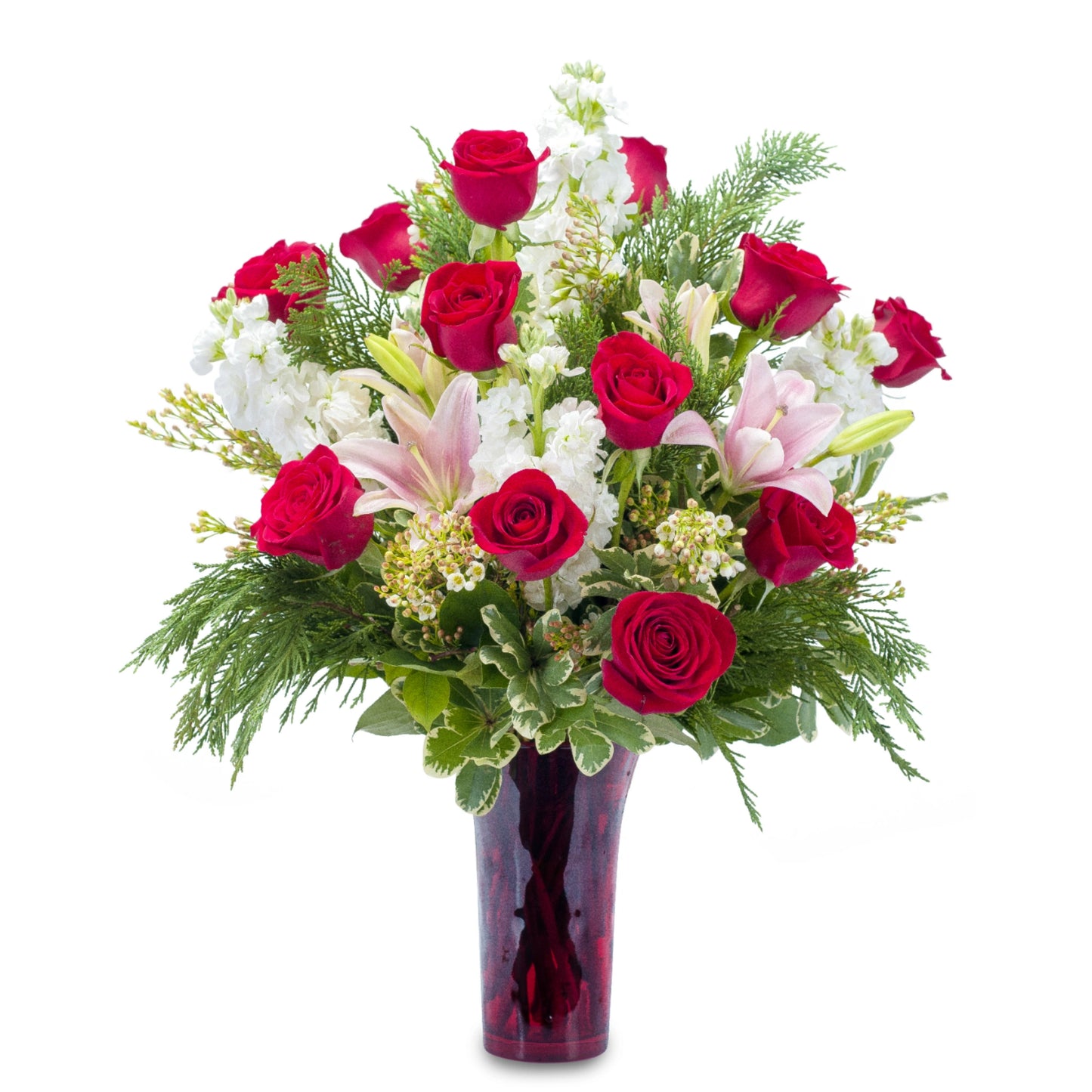 Seasonal Love Bouquet featuring lush combination of red roses and other pink and white flowers in a red vase