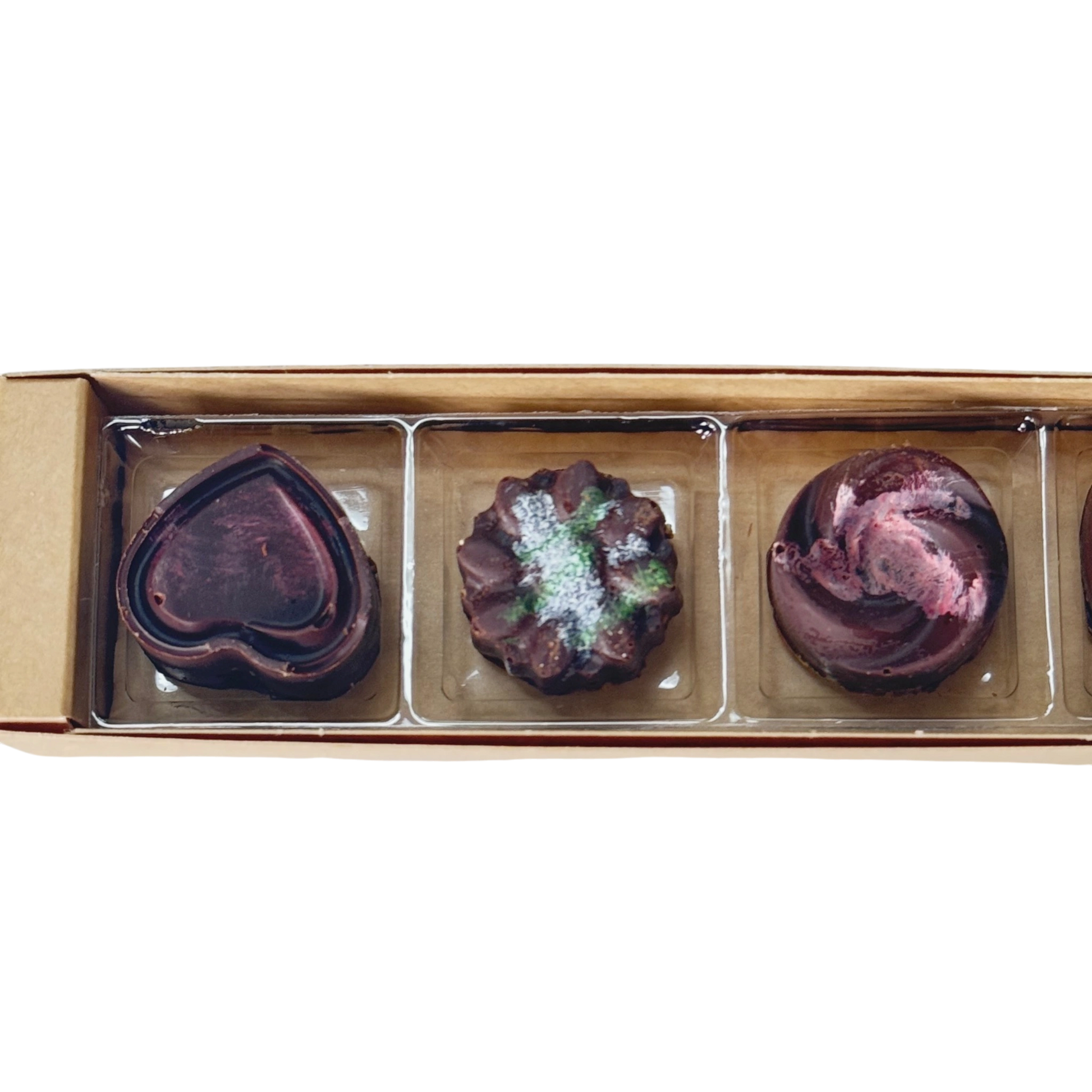 Luxurious dark chocolate pralines with rich filling and texture made in Houston, TX by Mela's Cookies now available at Scent & Violet on Westheimer Rd.