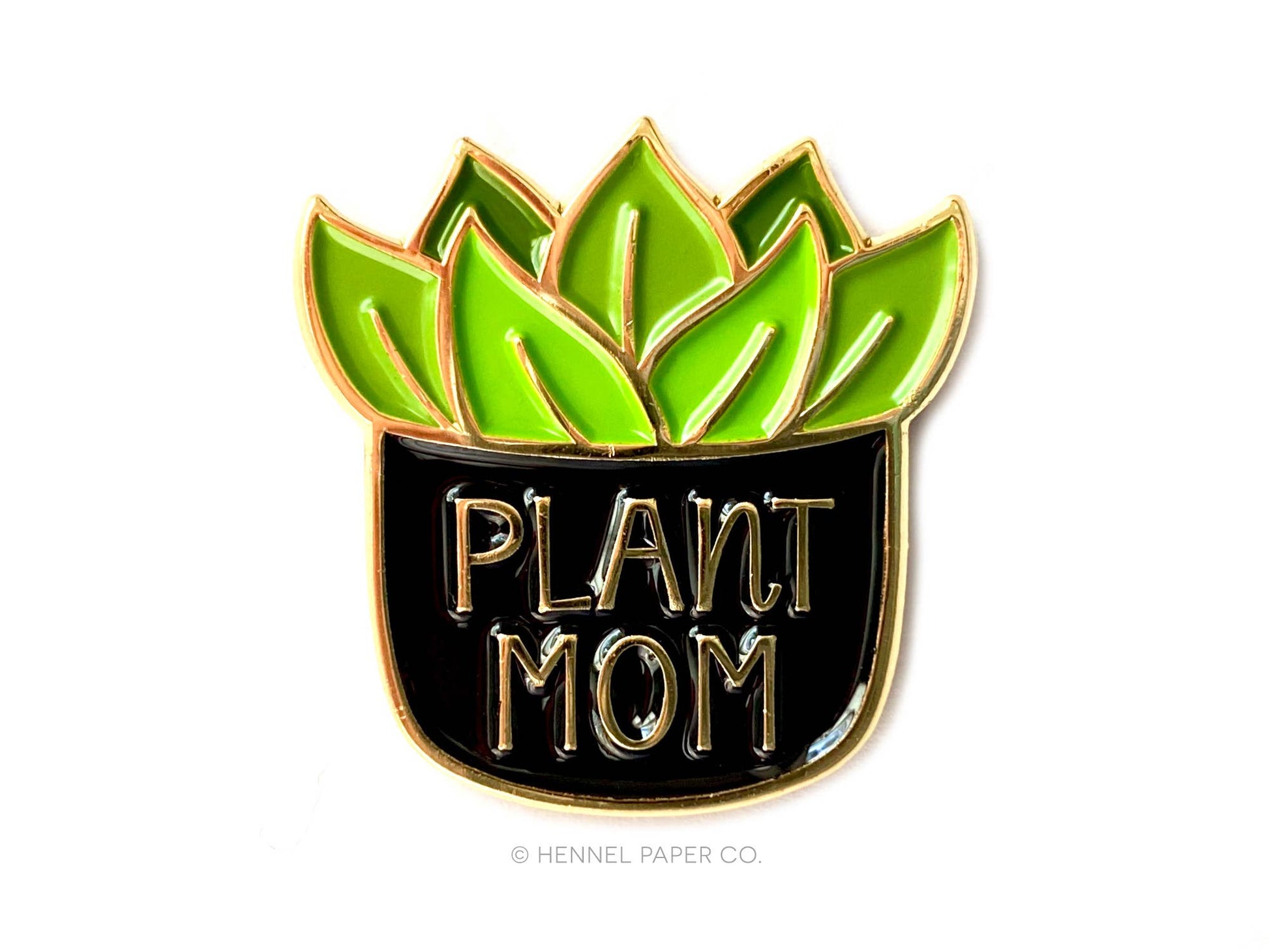 enamel pin with green leaves and 'Plant Mom' text 