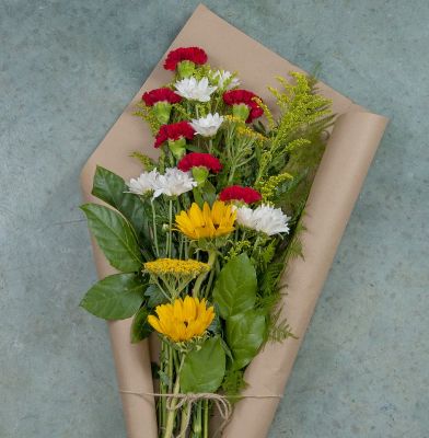Bouquet of flowers wrapped in brown paper 
