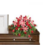 CALL FOR AVAILABILITY Stargazers and roses casket spray  in Houston, TX