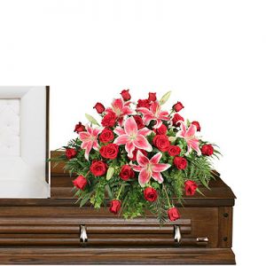 CALL FOR AVAILABILITY Stargazers and roses casket spray  in Houston, TX